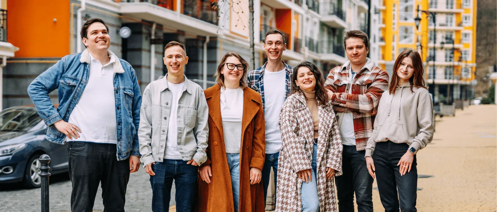 The Wild.Codes team on a street, seven people smiling
